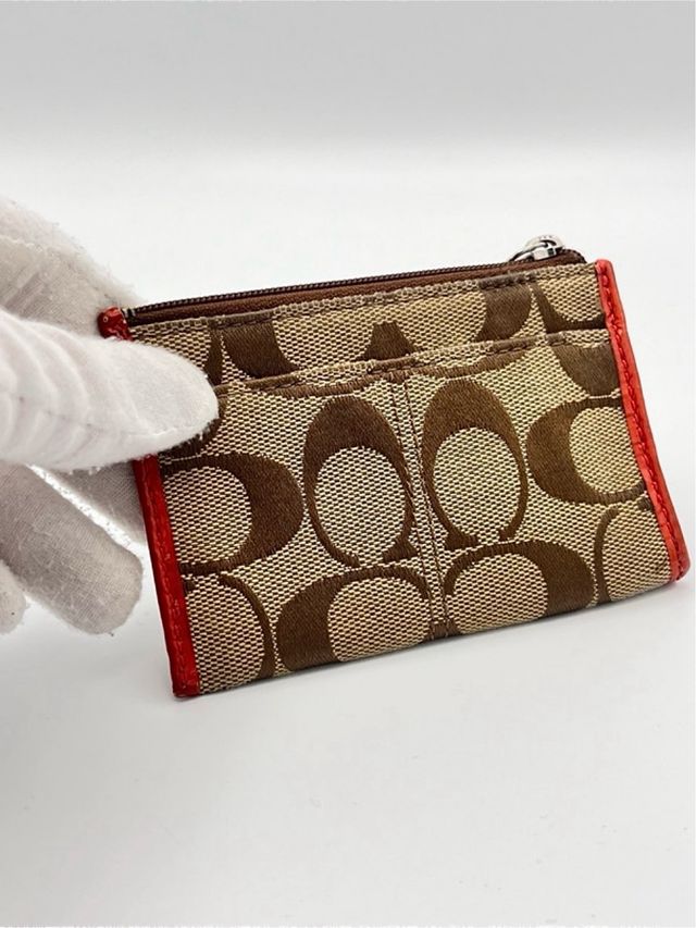 Portamonete Coach marrone in tessuto e in pelle