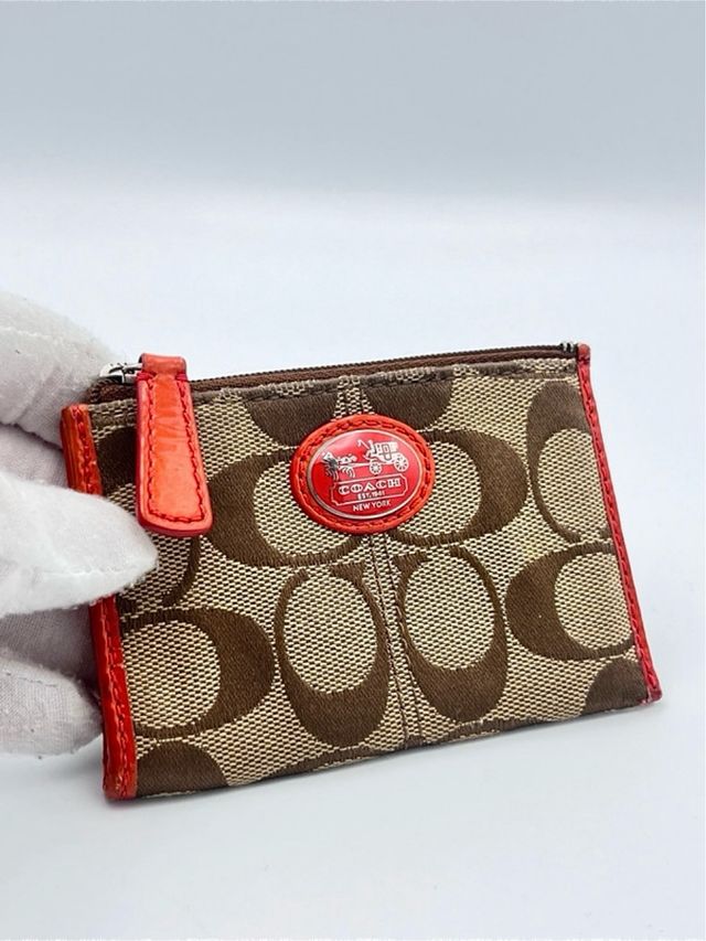 Portamonete Coach marrone in tessuto e in pelle