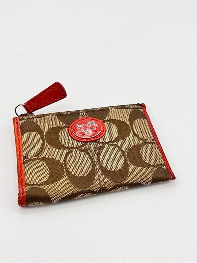 Portamonete Coach marrone in tessuto e in pelle