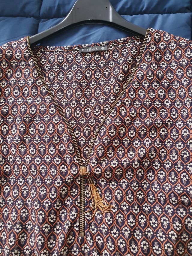 Bluse a fantasia con cerniera dorata