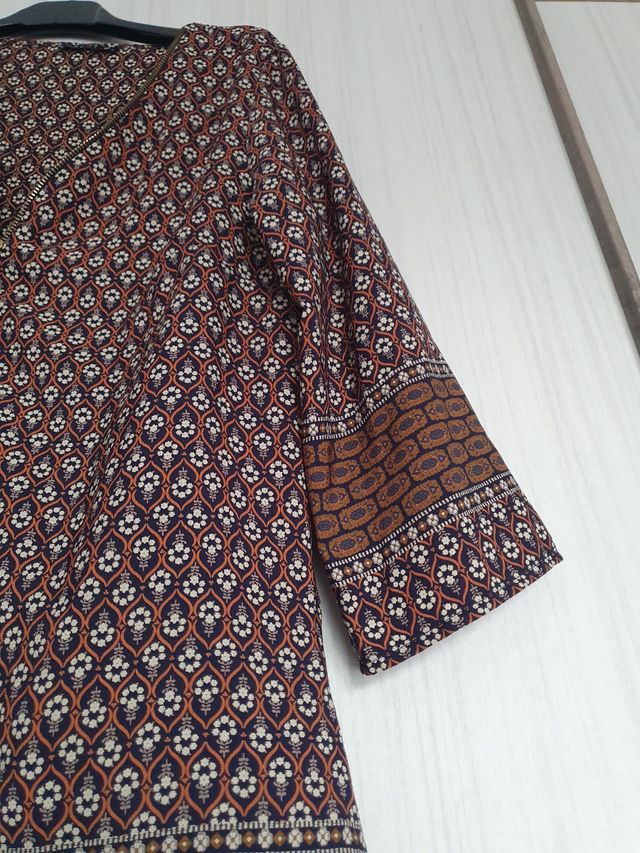 Bluse a fantasia con cerniera dorata