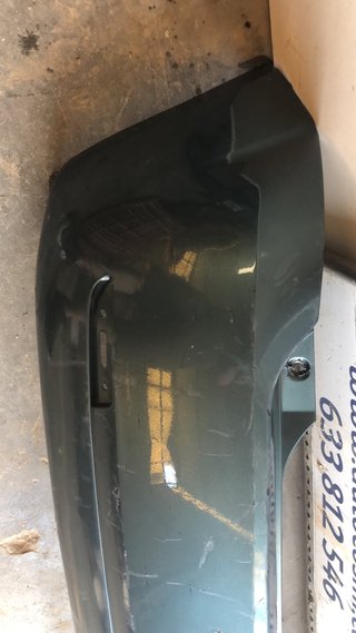 PARAGOLPES TRASERO FORD FIESTA 2005 GRIS OSCURO
