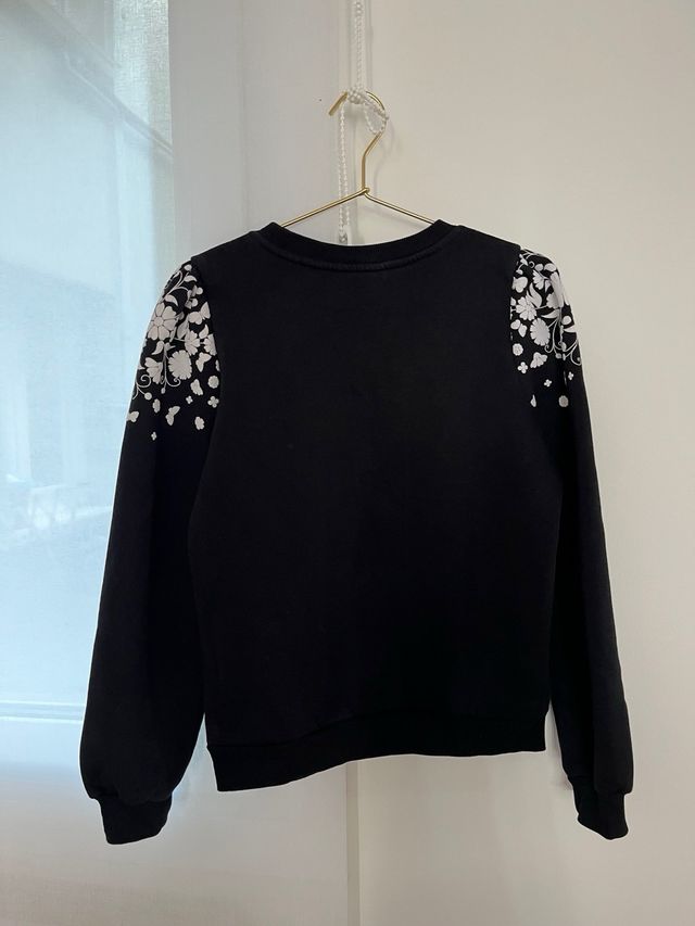 Sudadera negra con flores blancas