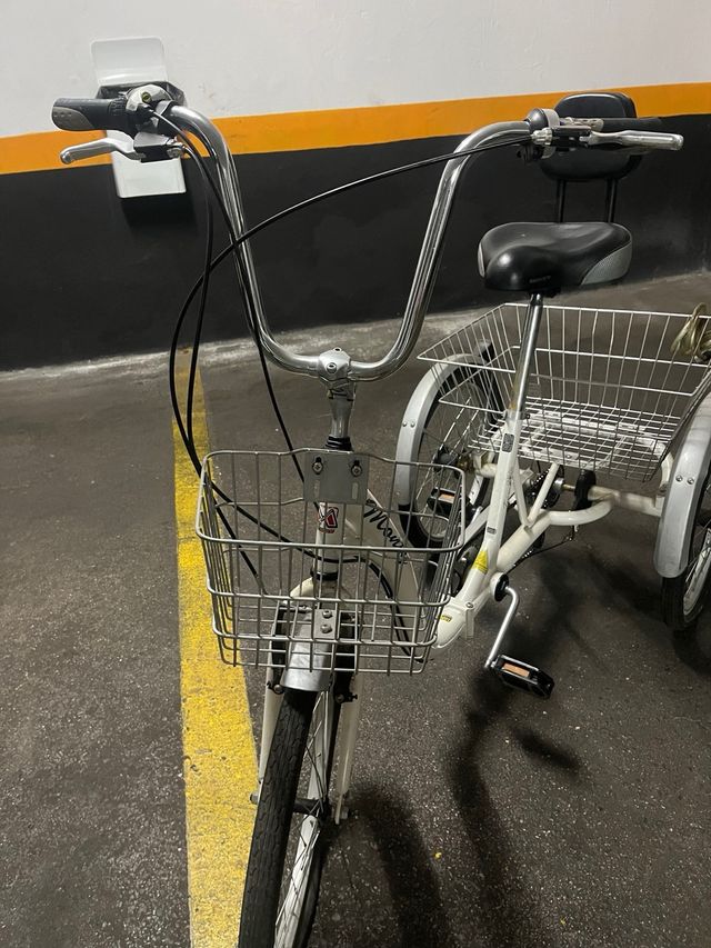 Bicileta triciclo blanca con dos cestas