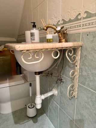 Mueble de baño pequeño con lavabo y grifo
