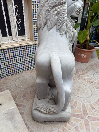 Pareja de esculturas de leones tallados en mármol.