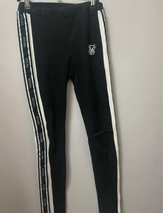 Conjunto Siksilk: Leggings negros y top rojo.