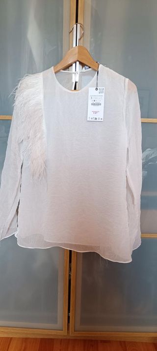 Blusa plumas