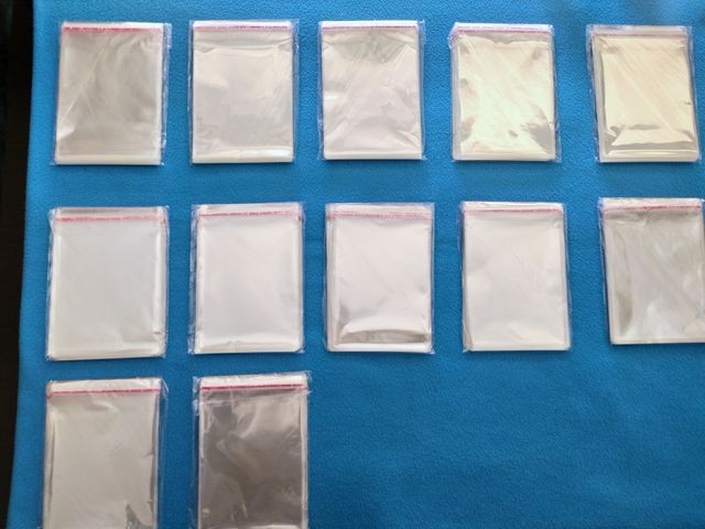 12 Confezioni -- 100 Bustine Plastificate -- Carte