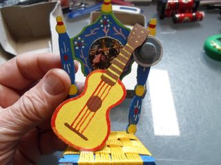 Miniatura de una silla con guitarra