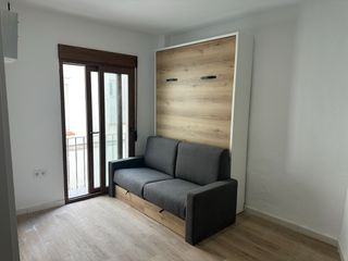 Cama abatible vertical con sofá cama