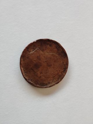 Moneda antigua de cobre de 10 céntimos desgastada.