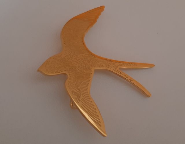 Spilla rondine in metallo dorato