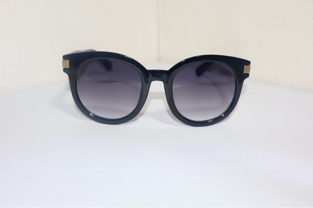 Gafas de sol redondas negras y doradas