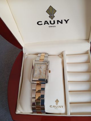 Reloj Cauny plateado y dorado, muy bueno