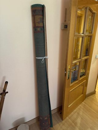 Alfombra étnica verde y naranja.