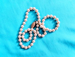 Collar de perlas con broche dorado