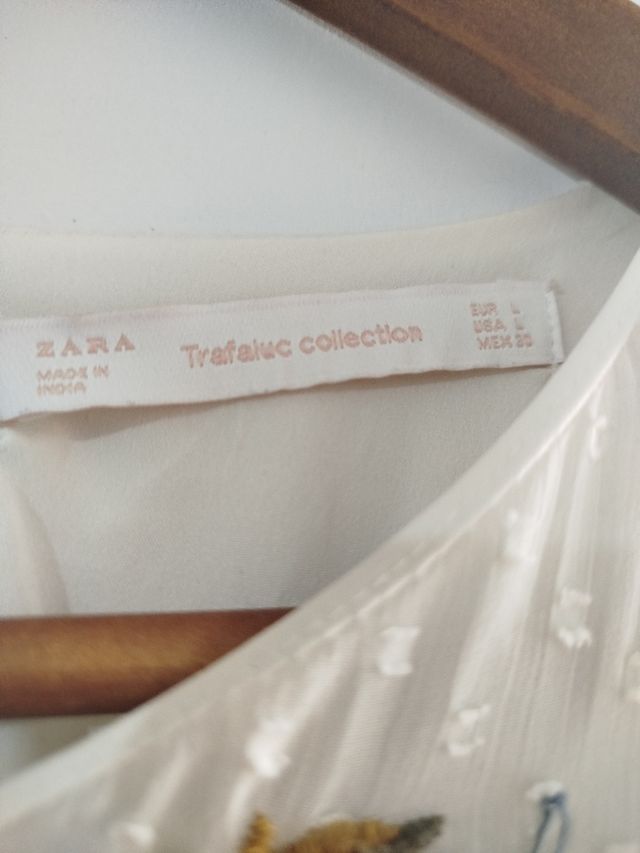 Vestido corto en color crudo con pantalón .