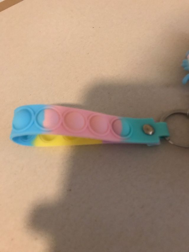 Llavero Popit Astronauta y bola de pelo rosa