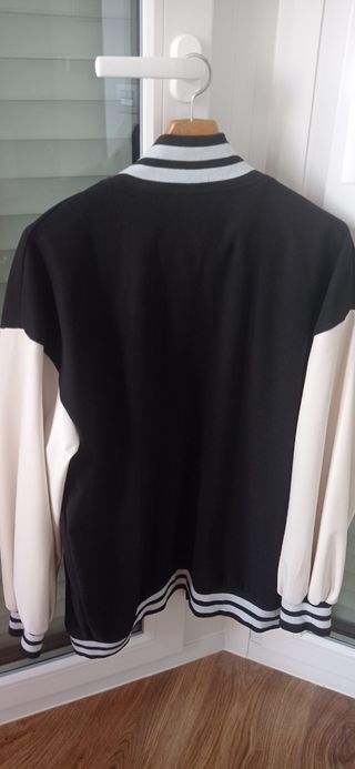 Chaqueta universitaria negra y blanca.