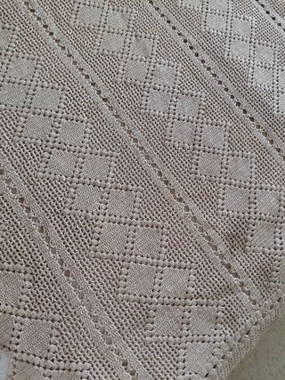 Colcha beige de crochet, hecha a mano.