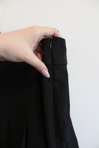 Mini falda negra plisada