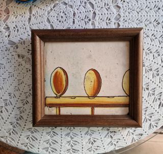 Antica piastrella con motivi di cucina, incorniciata.