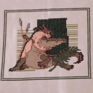 Bordado punto de cruz tarzan contra caiman