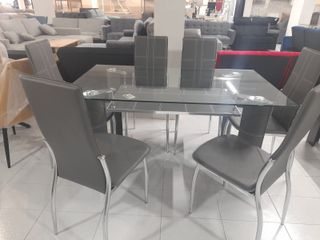mesa de crital + 6 sillass en polipiel nuevas