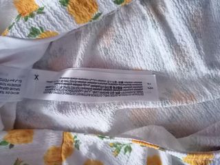 Top Bershka blanco con flores amarillas