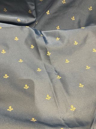 Cortina satén azul y dorada y volante ventana.