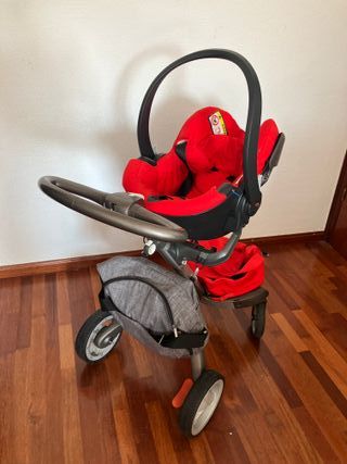 Cochecito Stokke rojo + silla + capazo + accesorio