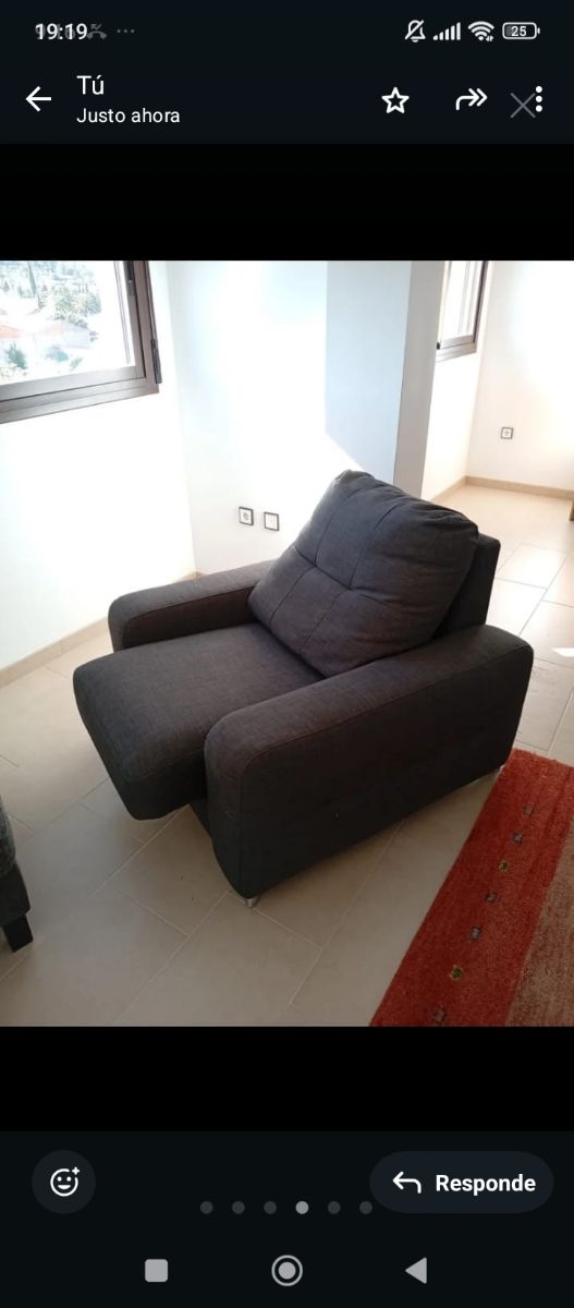 Sillón individual gris-azulado con reposapiés