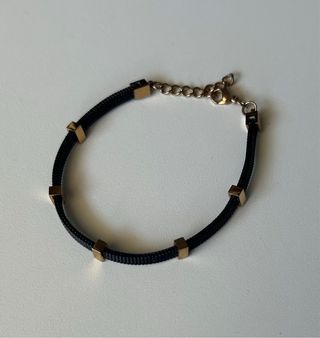 Pulsera negra y dorado rosa