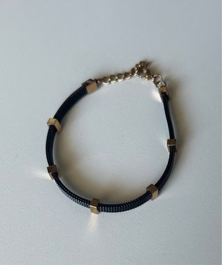 Pulsera negra y dorado rosa