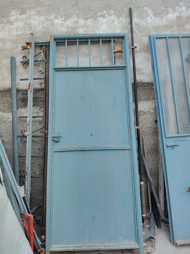 Puerta metálica azul con marco