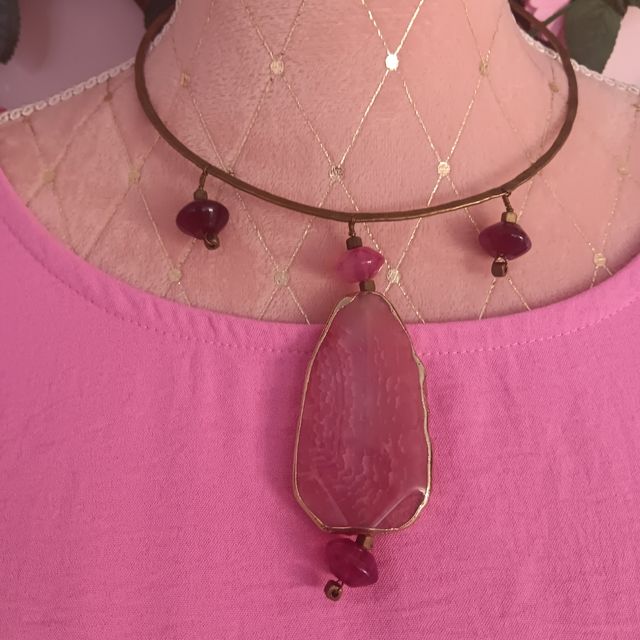 Collar y pulsera dorados con piedras rosas