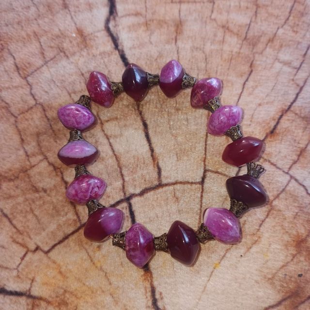 Collar y pulsera dorados con piedras rosas