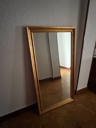 Espejo con marco dorado de madera.