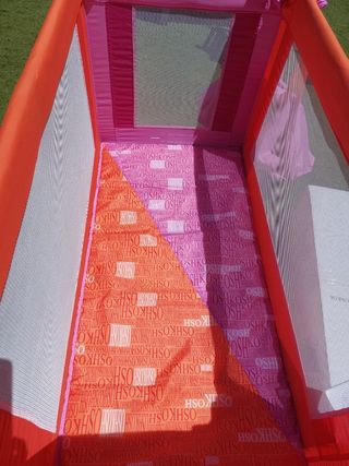 Cuna viaje OshKosh rosa-naranja.