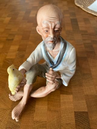 Figura porcelana anciano pájaro