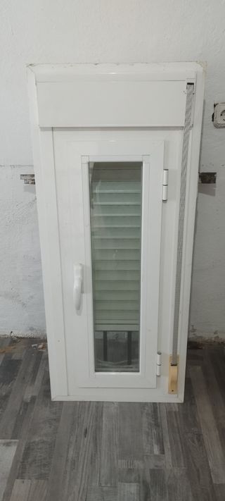 Ventana climalit con persiana y reja