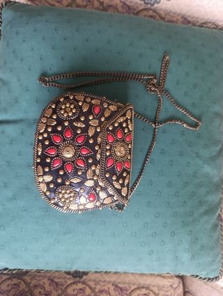 Bolso étnico metal dorado.