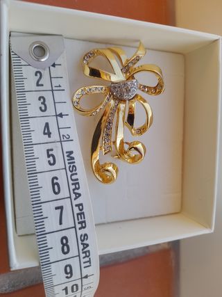 Spilla fiocco oro e cristalli