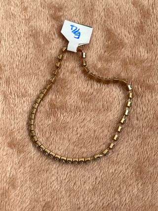 Pulsera de tenis dorada con brillantes