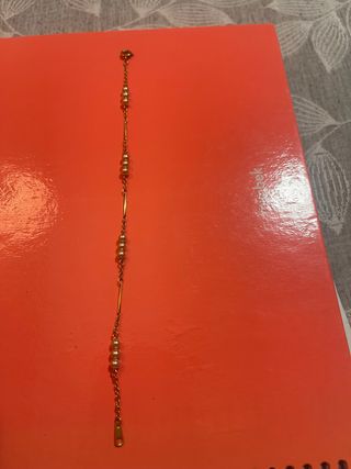 Pulsera dorada con perlas doradas