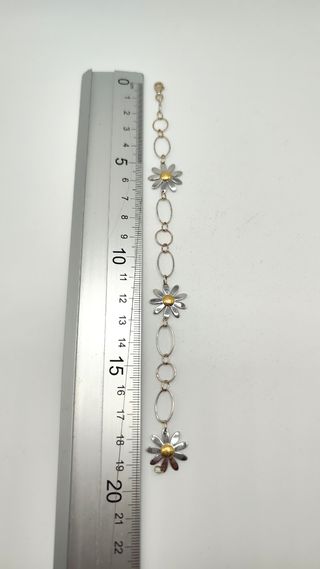Pulsera oro blanco con margaritas en oro mixto 18k