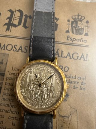 Reloj chapado oro con moneda en la esfera
!oferta!