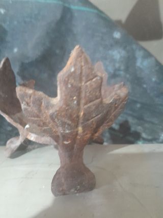 Soporte metálico tallado en forma de hojas oxidada