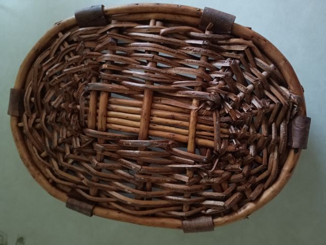 Cesta de mimbre marrón con asas de madera